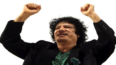 muammar-qaddafi-hands-raised.jpg